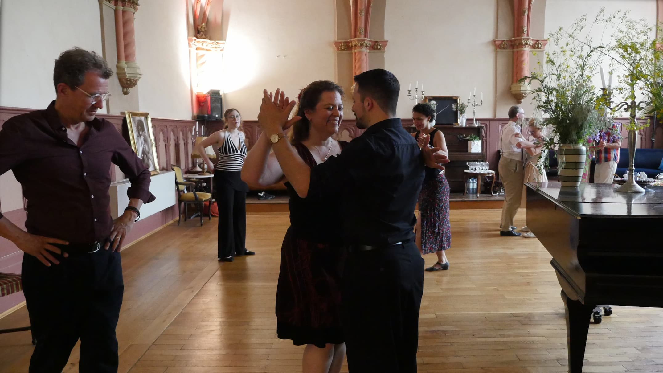 Freudige Schülerin, die mit ihrem Tango-Lehrer Fadi im Lernprozess ist